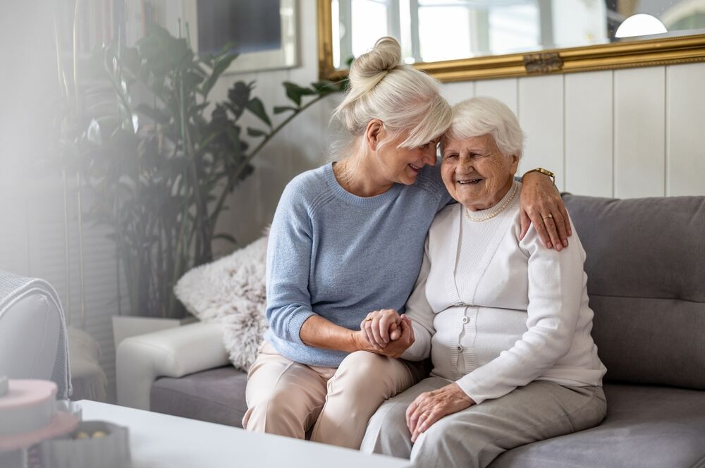 Happy,Senior,Woman,With,Her,Adult,Daughter,At,Home