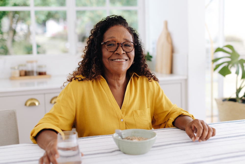 A senior woman eating a healthy breakfast at the memory care community in Loomis