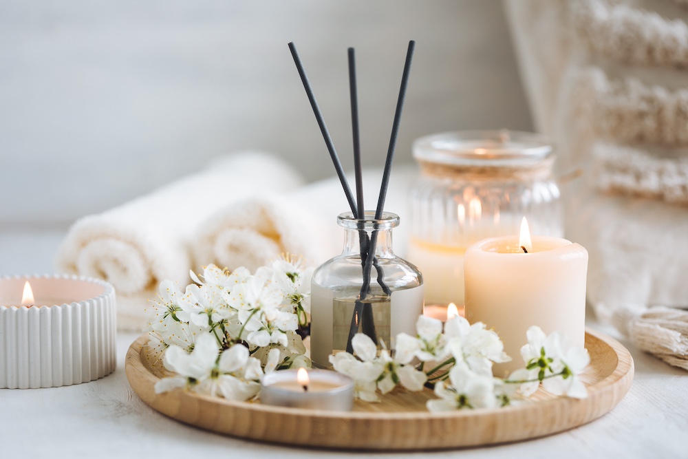 An arrangement of candles and oil diffuser