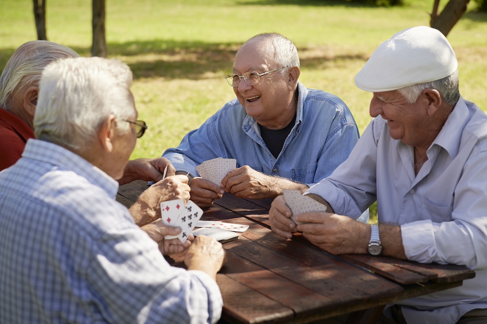 A group of senior friends playing cards together at the Alzheimer's care services in Loomis