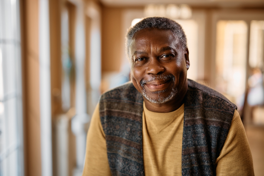 Senior man smiling in best memory care communities.