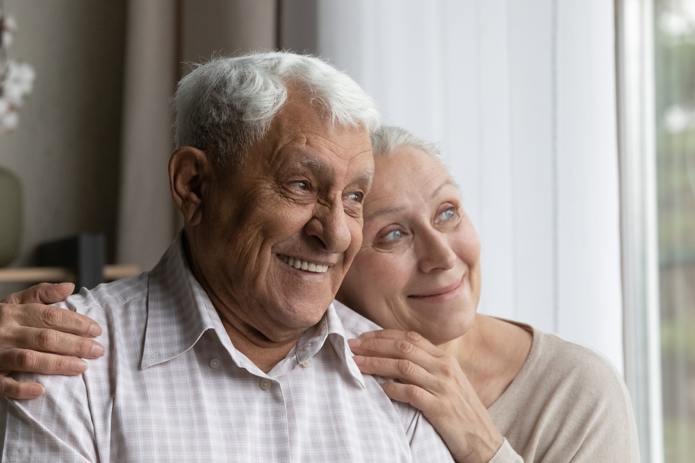 Happy senior couple receiving alzheimer care services.