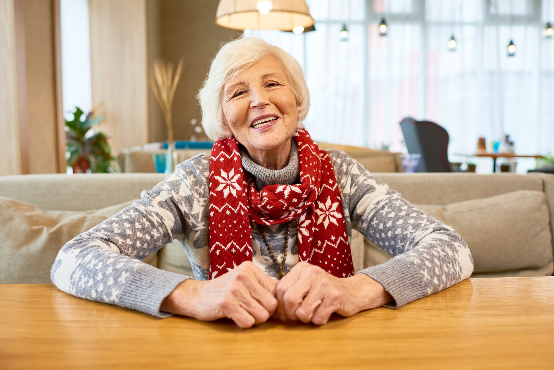 Senior woman in dementia care near Loomis in Christmas scarf.