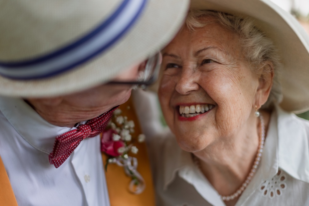 Senior couple looking at each other and talking about the benefits of Senior Living Community